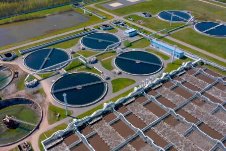 Aerial view of the wastewater treatment plant. Pumping station and drinking water supply. Industrial and urban water treatment for a big city. Round sedimentation tanks.